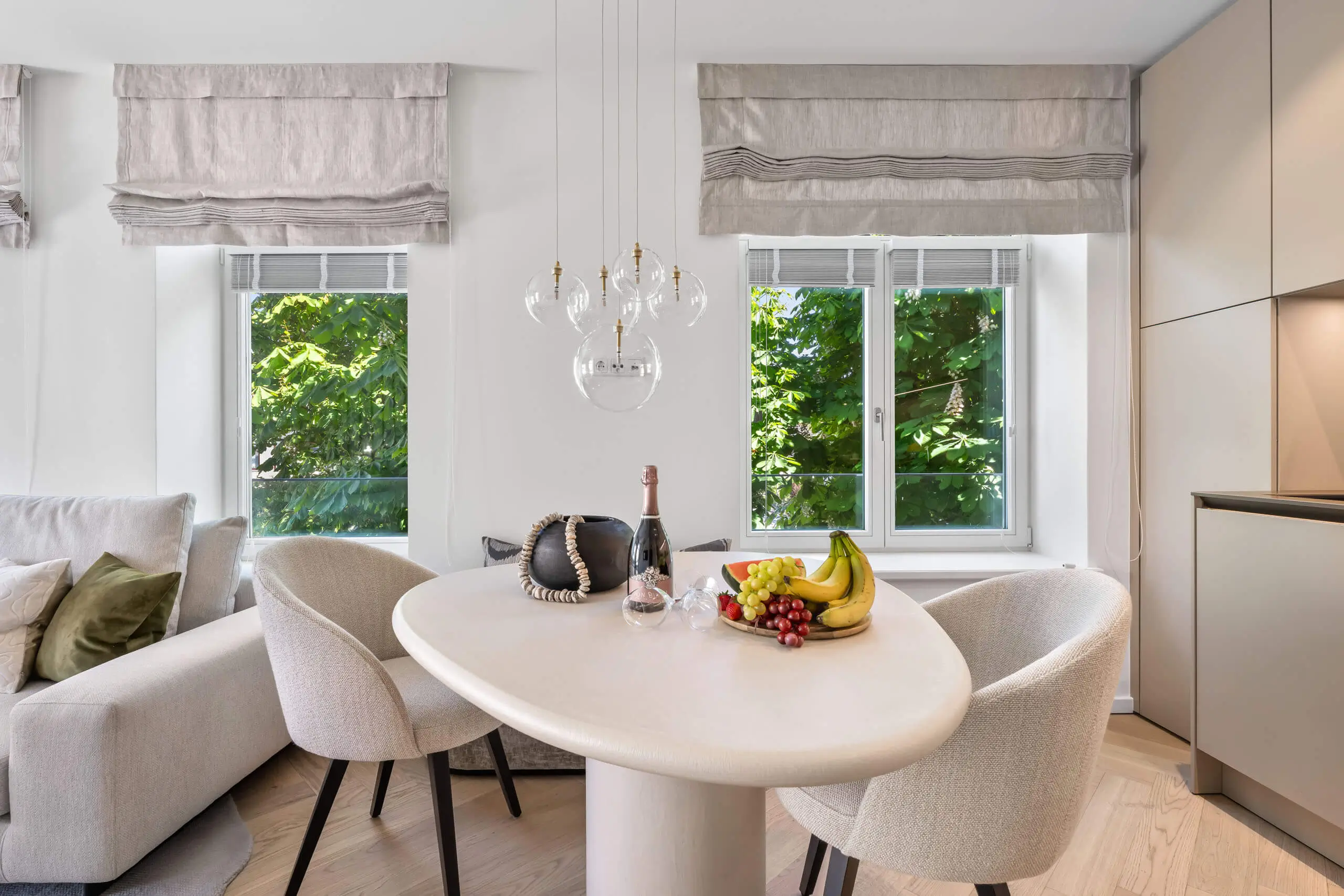 Modernes Hotelzimmer mit Tisch, Obst und Champagner. Luxus pur im Herzen von Sylt.