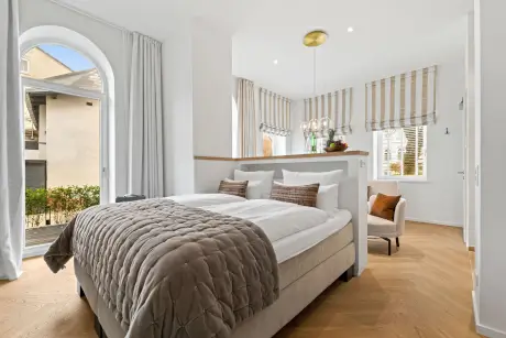 Modernes Hotelzimmer mit gemütlichem Bett und eleganter Einrichtung.