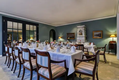 Elegante Tische mit Stühlen im Biedermeierzimmer des 12.18 Hotels in Sylt.